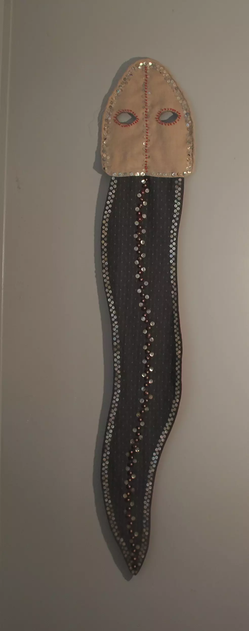 Snake Mask buttons, beads, embroidery on linen 45H x 12W 2021 Collection of Took Gallagher